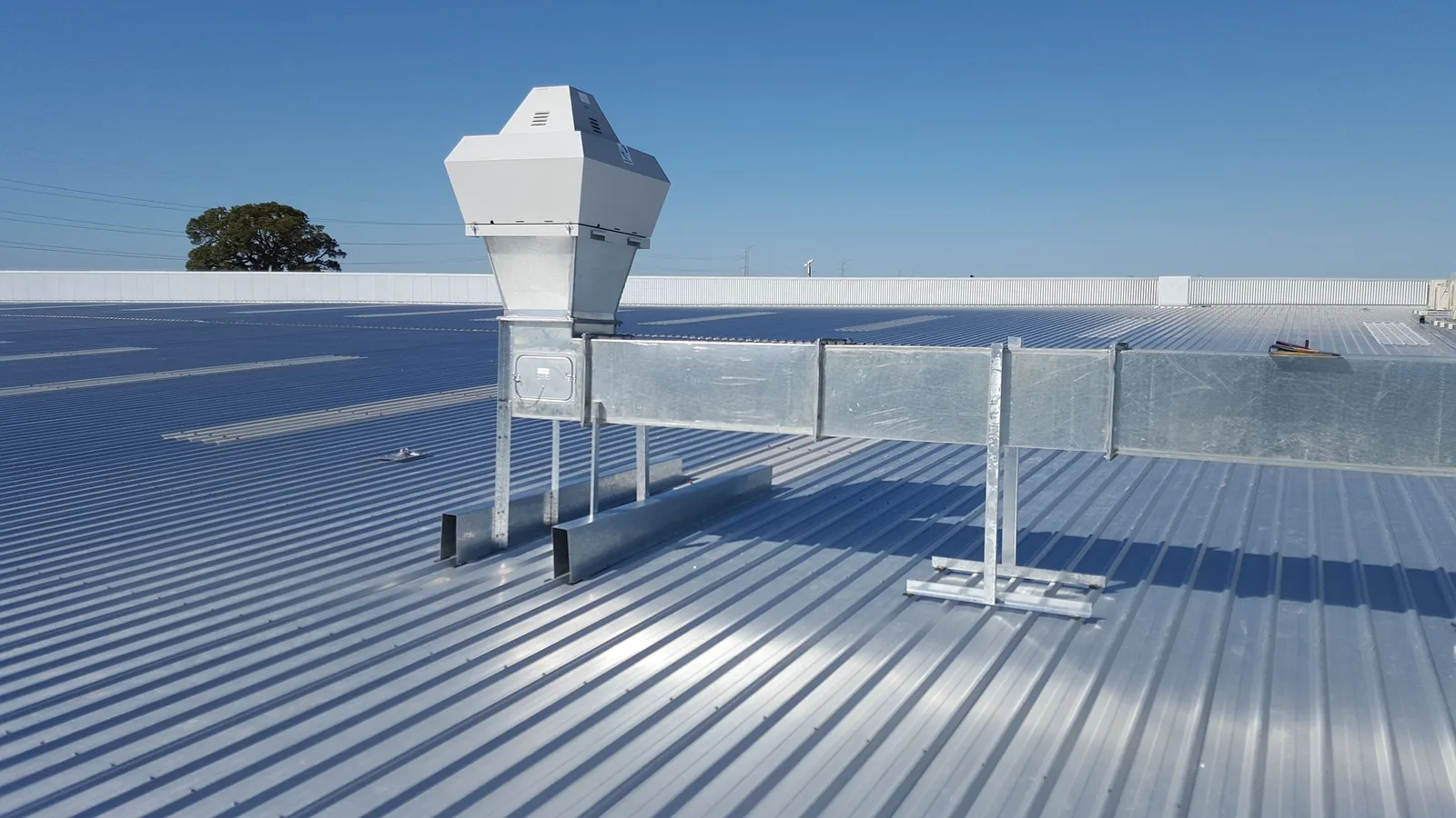 Low-slope metal roof with rooftop ventilation equipment